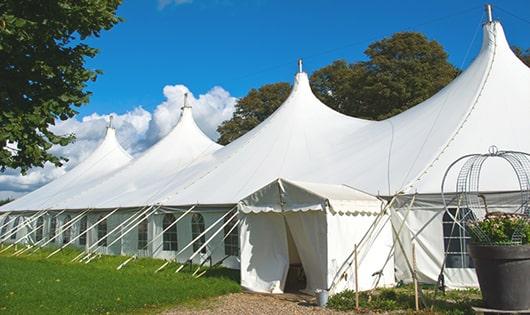 a row of portable restrooms placed outdoors for attendees of a event in Chepachet